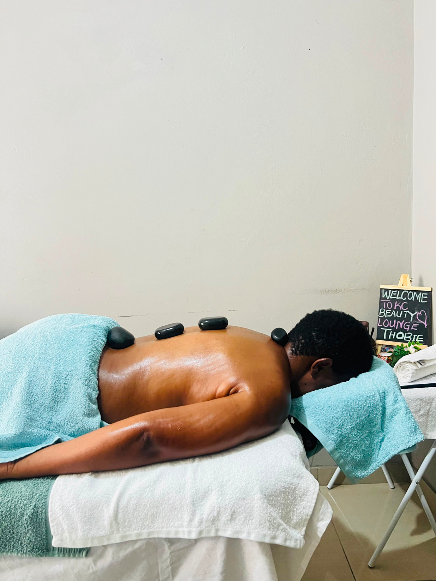 Hot stone massage in progress at KC Beauty Lounge