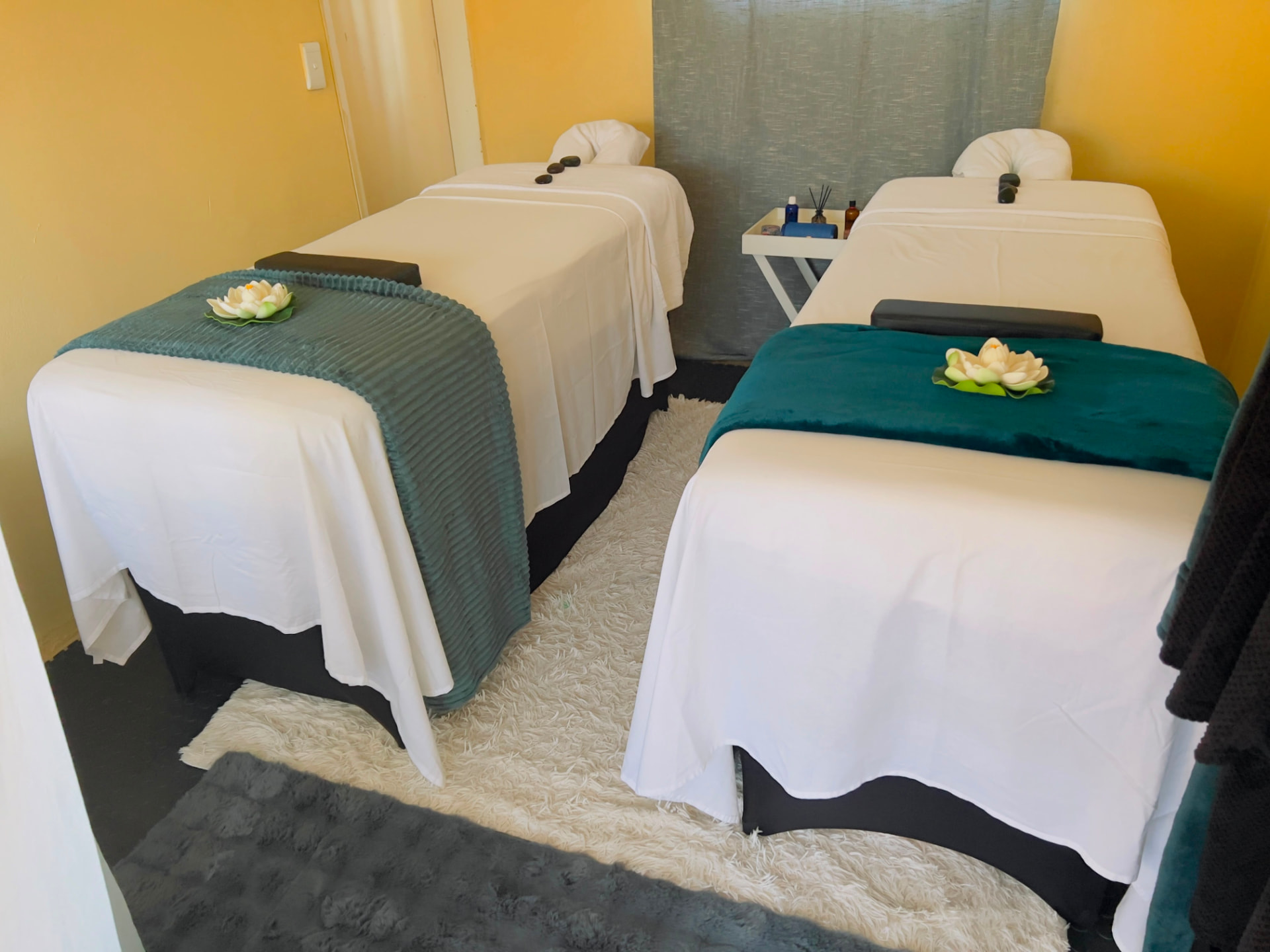 Couples massage beds prepared at KC Beauty Lounge