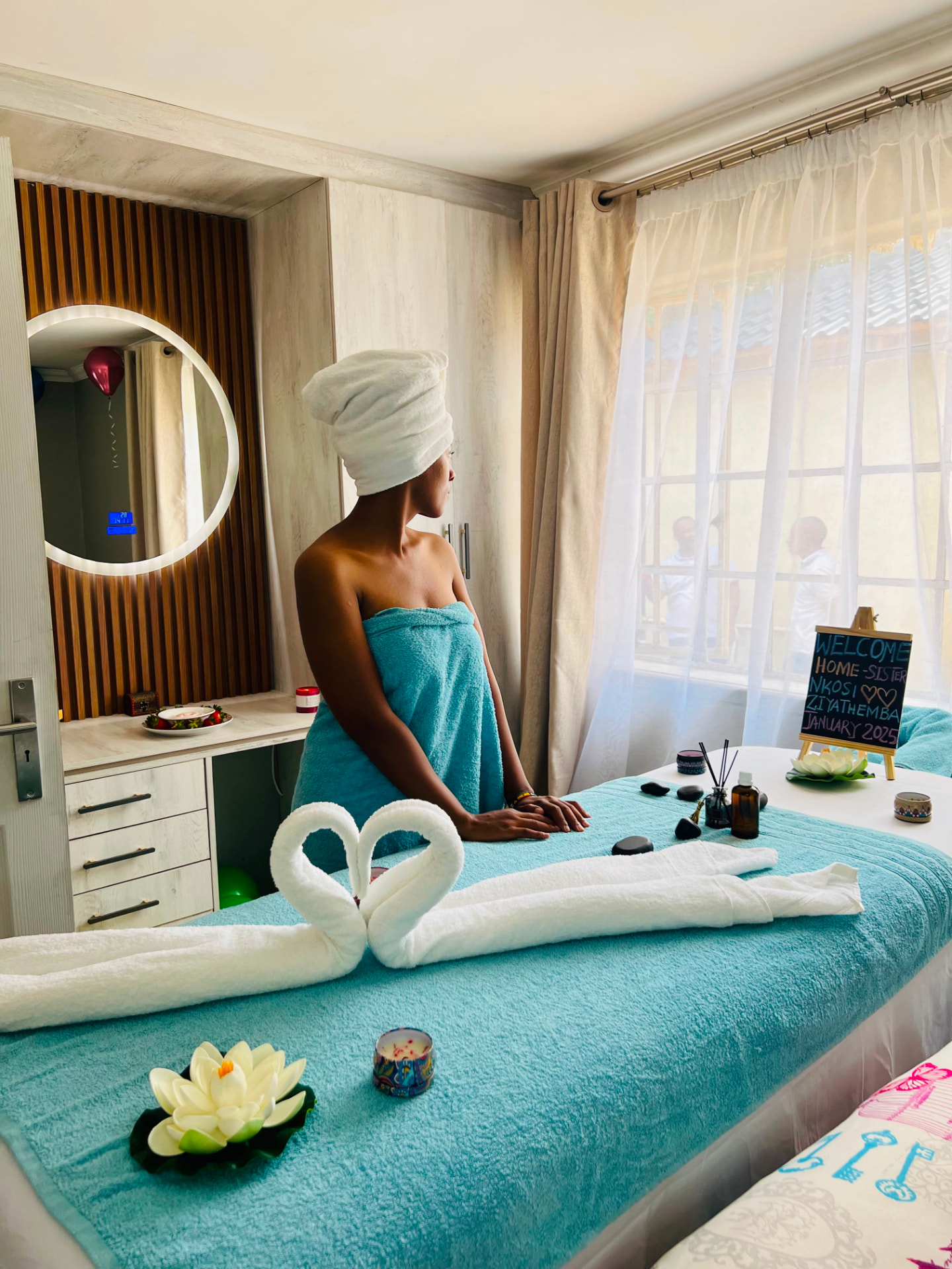 KC Beauty Lounge treatment room set up with towels and candles